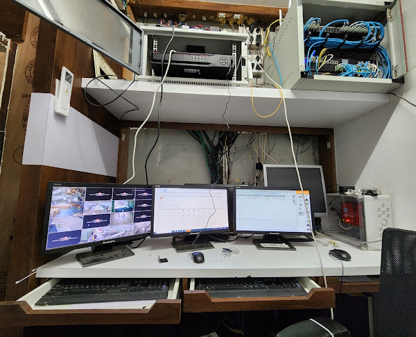 A monitoring workstation alongside recording and network equipment.