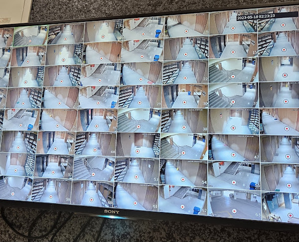 A multi-camera display showing corridors, stairways and common areas.